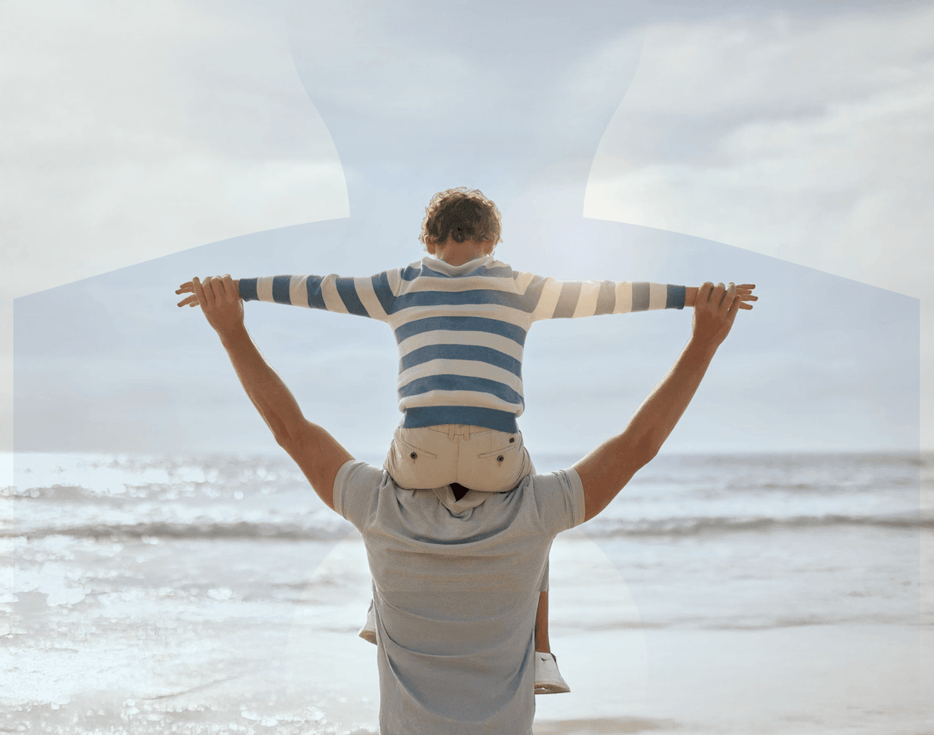 Father with child on his shoulders at the beach