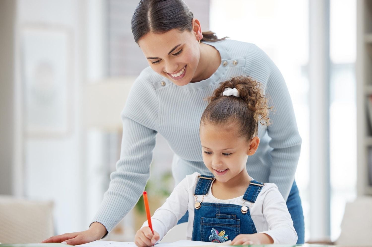 A parent supporting a child with a learning activity